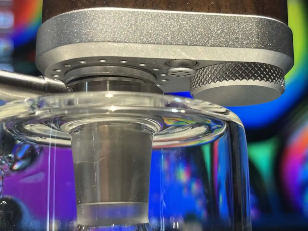 Closeup view of Tinymight 2 water pipe adapter, mated with glass bubbler.