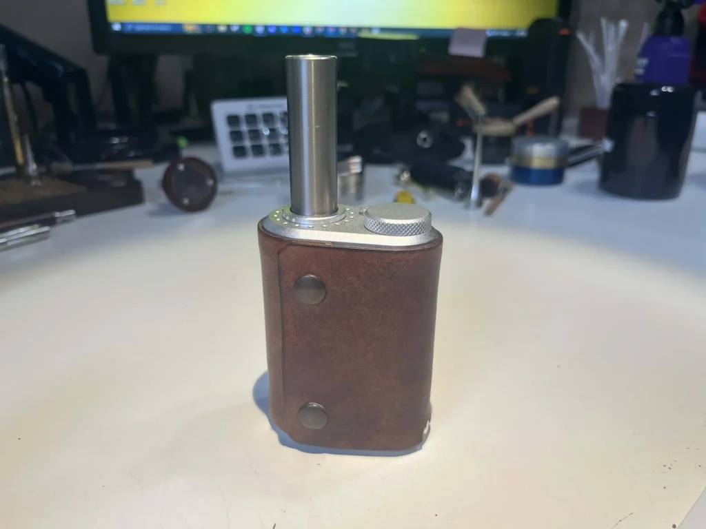 Tinymight 2 vaporizer with a titanium stem attached, clothed in a leather case from Labetkomp.