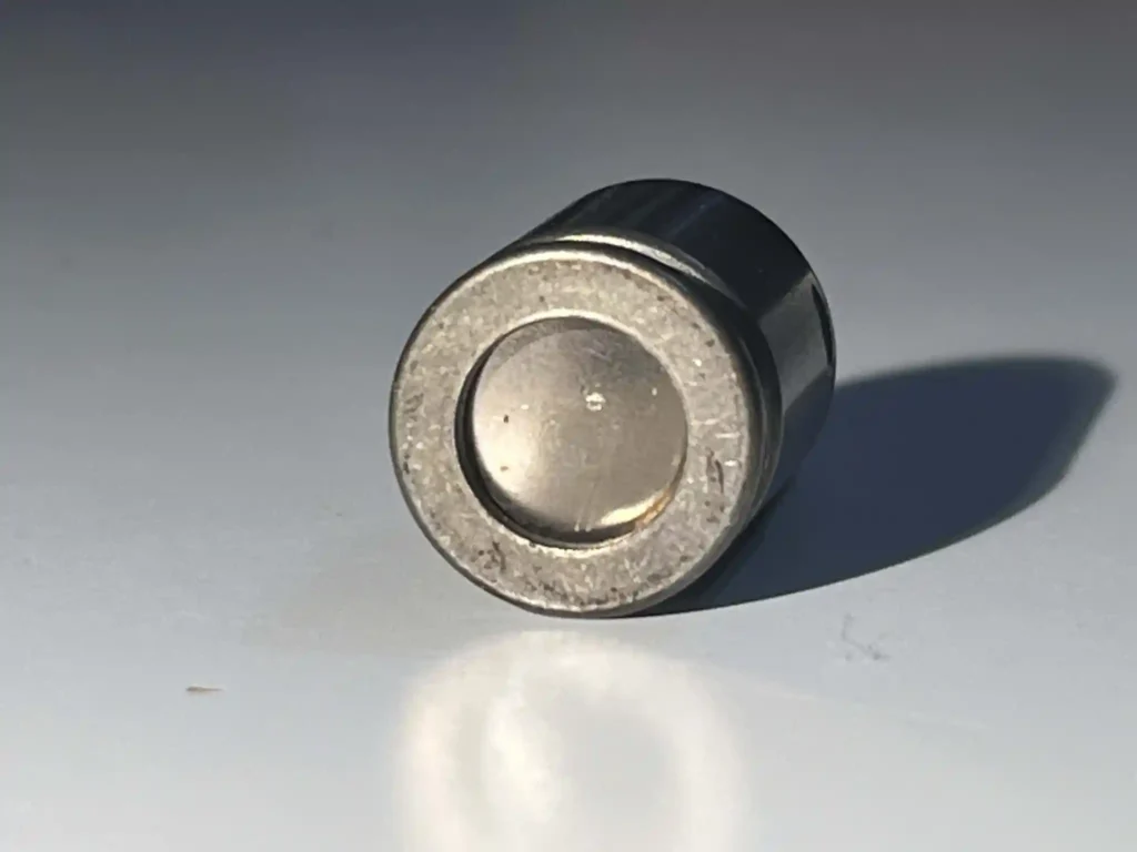 The top of the cap. You can see the click disk (thermostat), unlike the original caps.