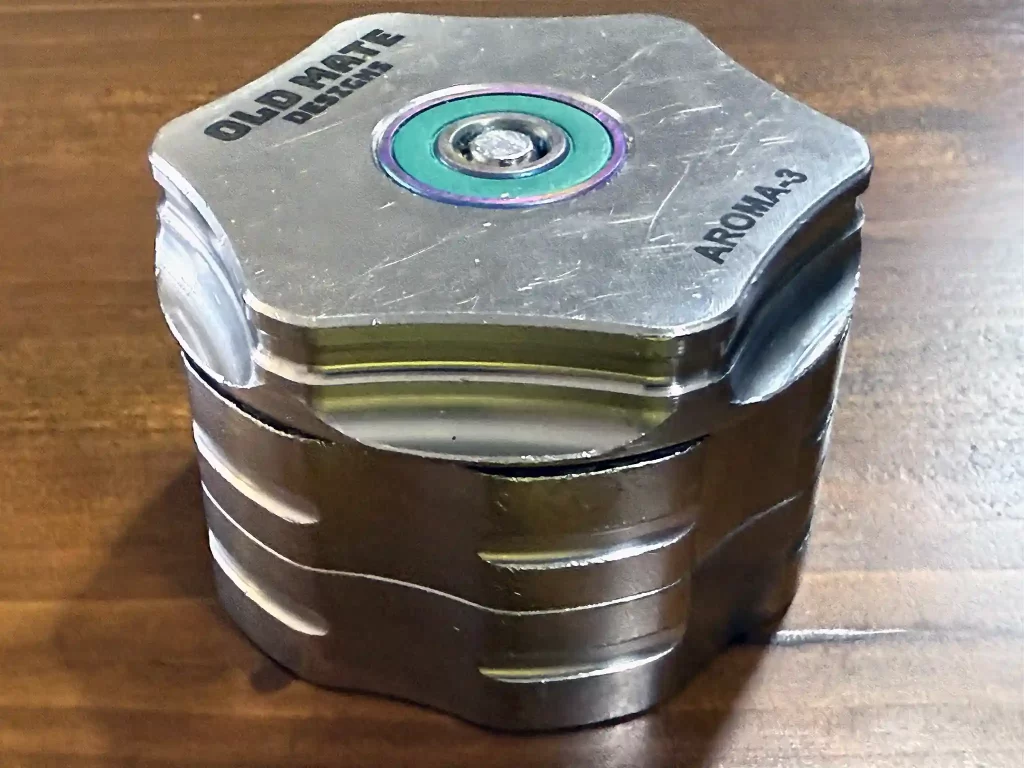 Side view of the aroma 3 stainless steel grinder shows the ball bearing top and grippy sides